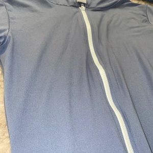 Periwinkle body suit. Has a good and short sleeve. White zipper in the front.